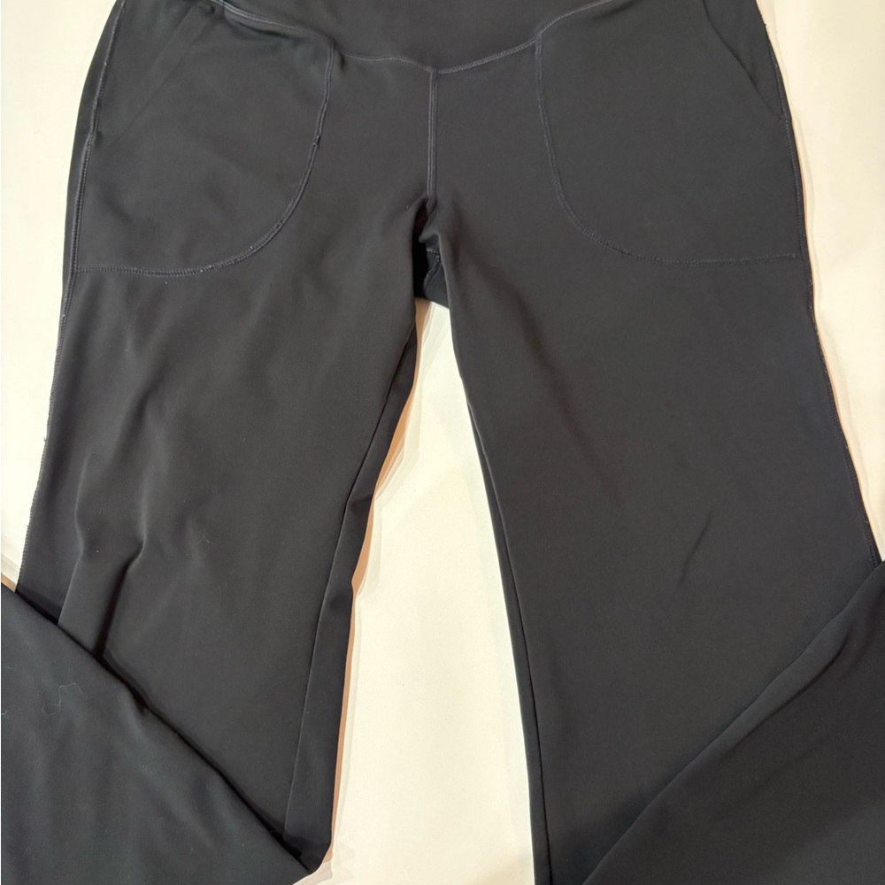 Black Yoga Pants With Front Pockets And Side Slit At Hem Size Medium.
